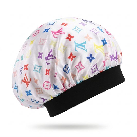 Side view of a white multicolor monogram hair bonnet with a wide black band on a white background