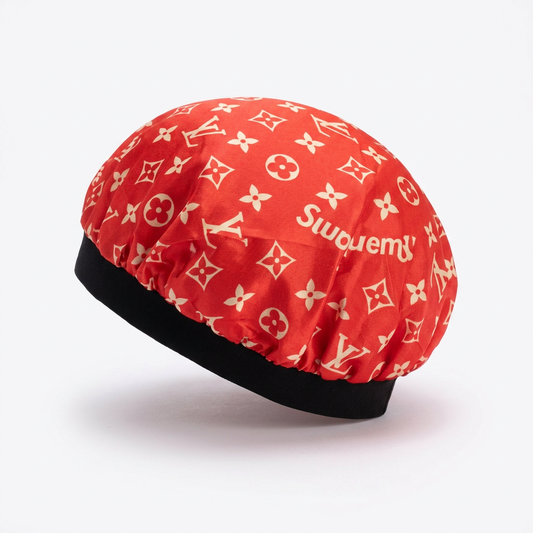 Red and cream print hair bonnet, side view on white
