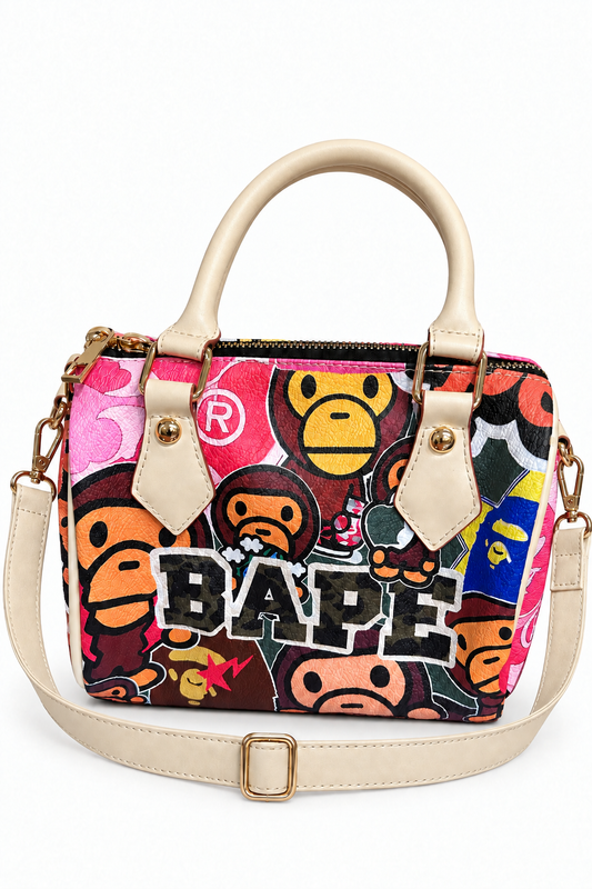 Digitally edited pink Bape graphic pillow bag with cream shoulder strap and unwrapped handle on white background